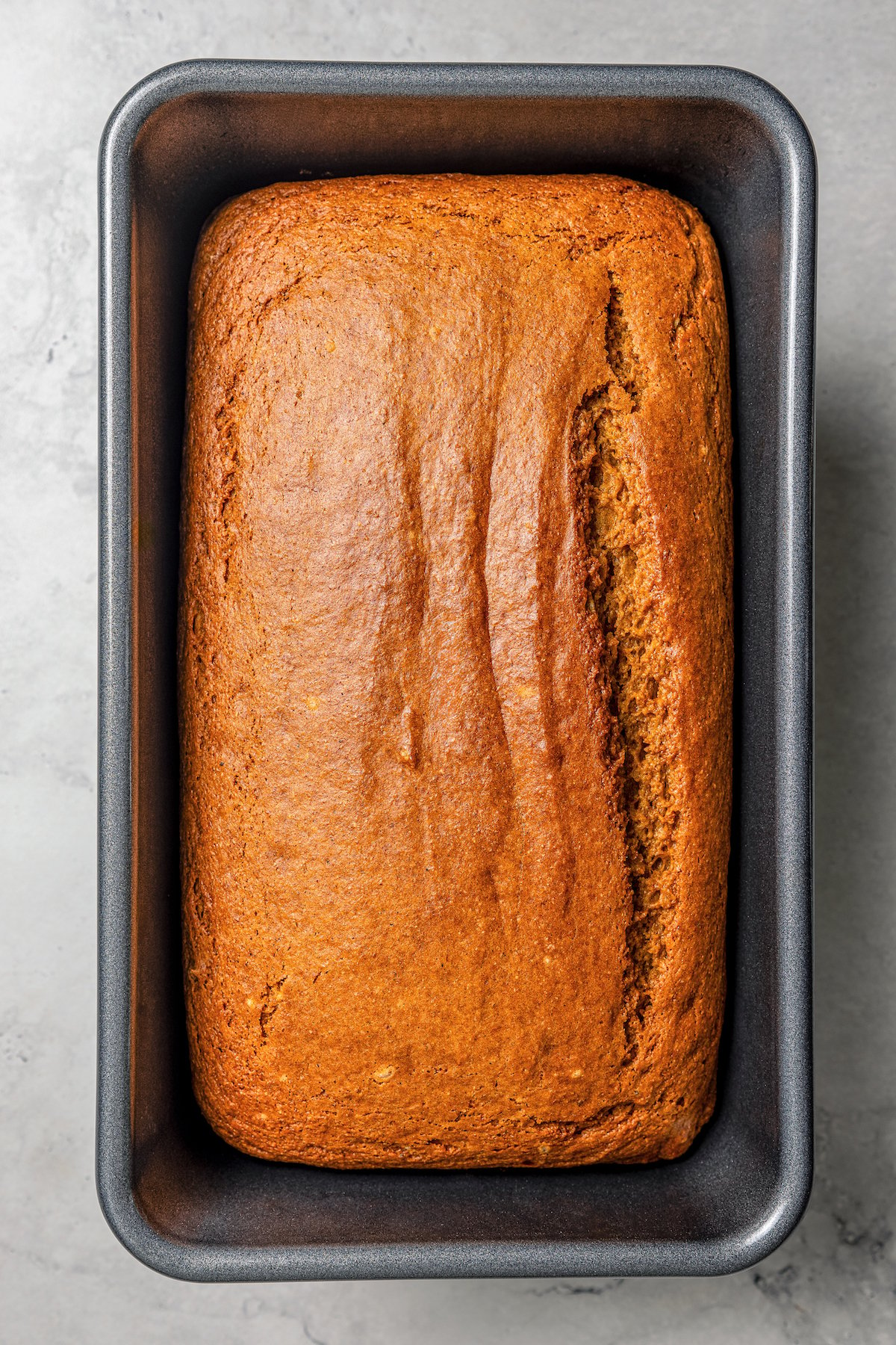 Baked pumpkin bread in the loaf pan.