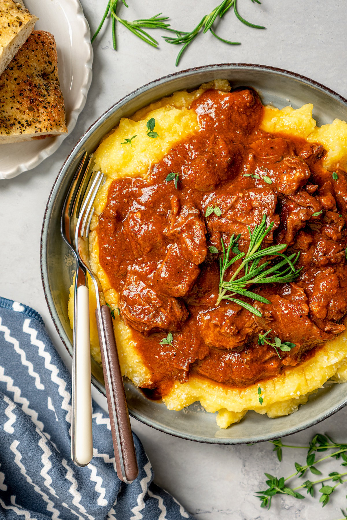 Tomatoey short ribs with fresh rosemary served over polenta. 