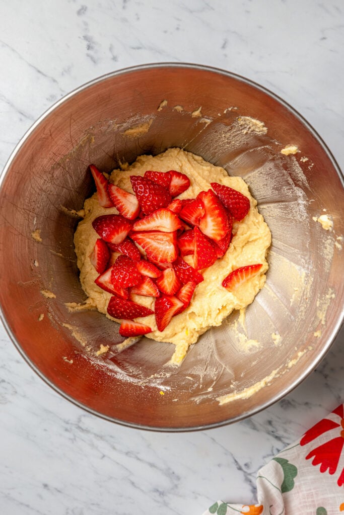 Adding the strawberries to the batter. 